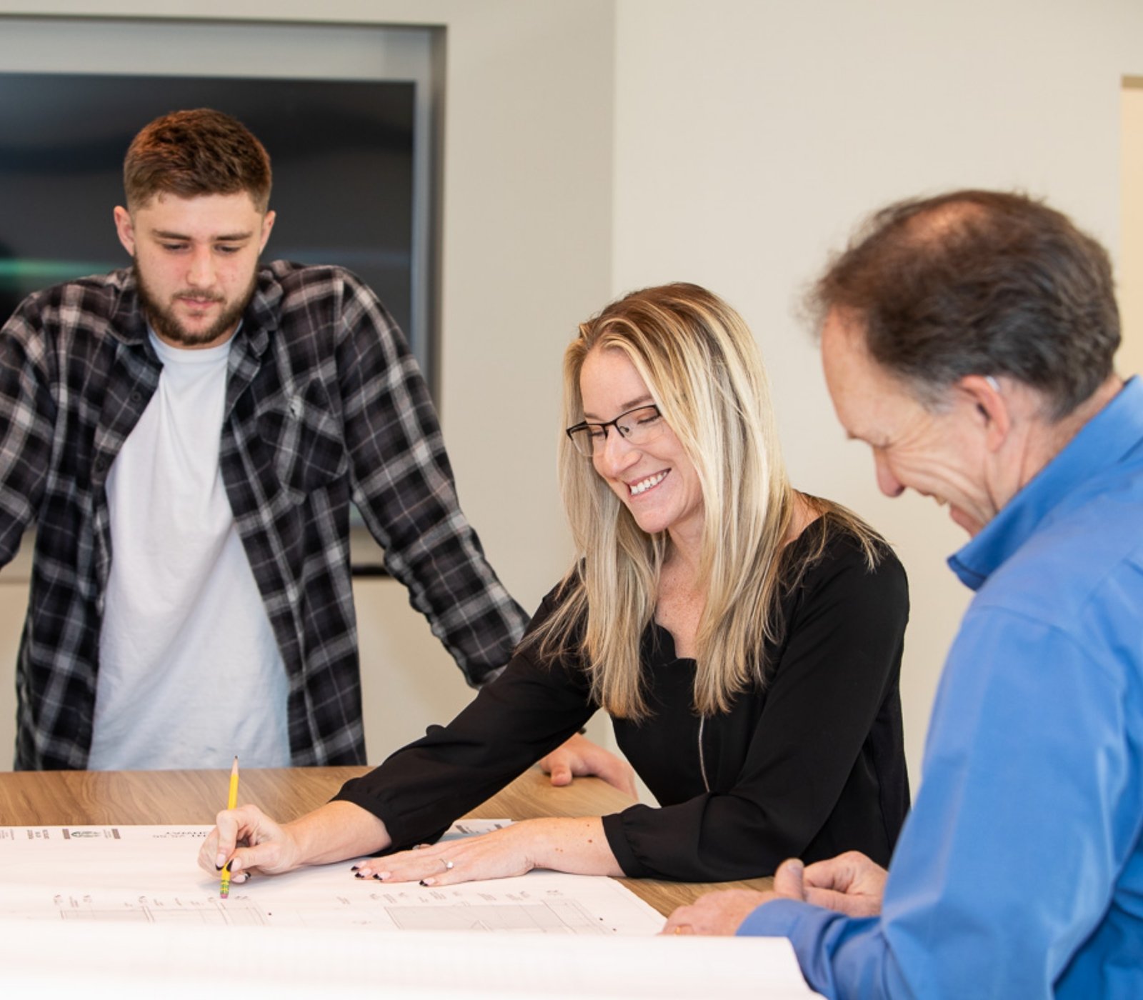 3 people working on blueprints