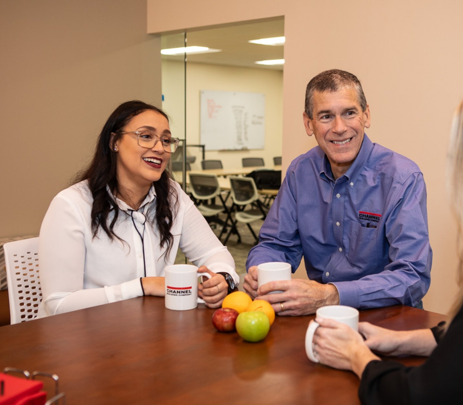 CHANNEL employees talking at a table